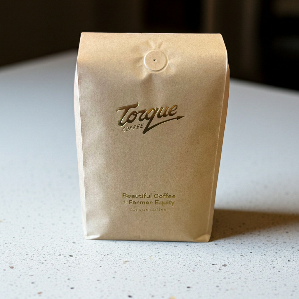 Torque Coffee bag on a light surface with a blurred background