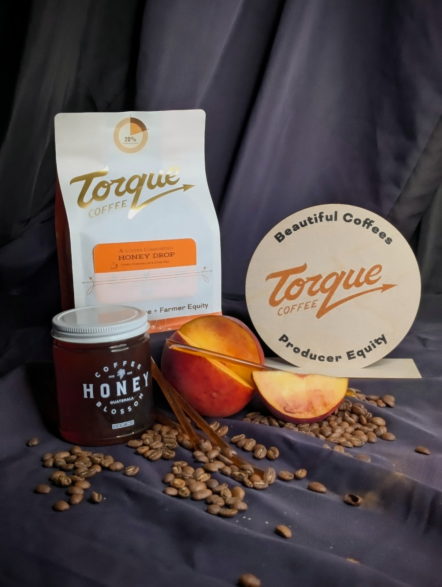 Torque Coffee products including a bag, jar, and coffee beans on a dark background